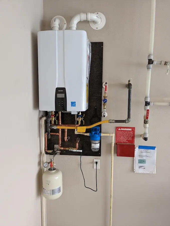 Professional plumber installing copper piping in a Peotone home